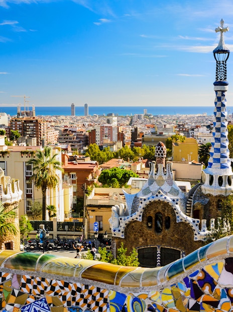 Park Güell mosaic terrace overlooking Barcelona cityscape, Spain.