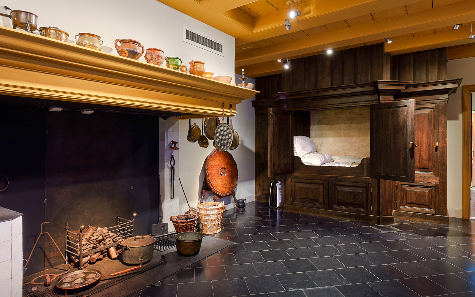 Rembrandt House Museum interior with historic kitchen and wooden bed alcove.