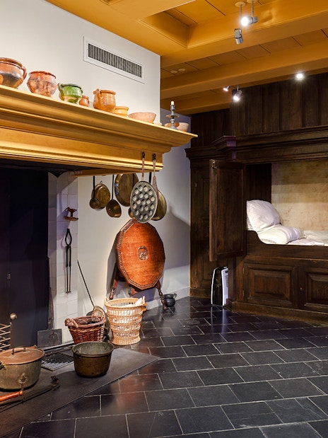 Rembrandt House Museum interior with historic kitchen and wooden bed alcove.