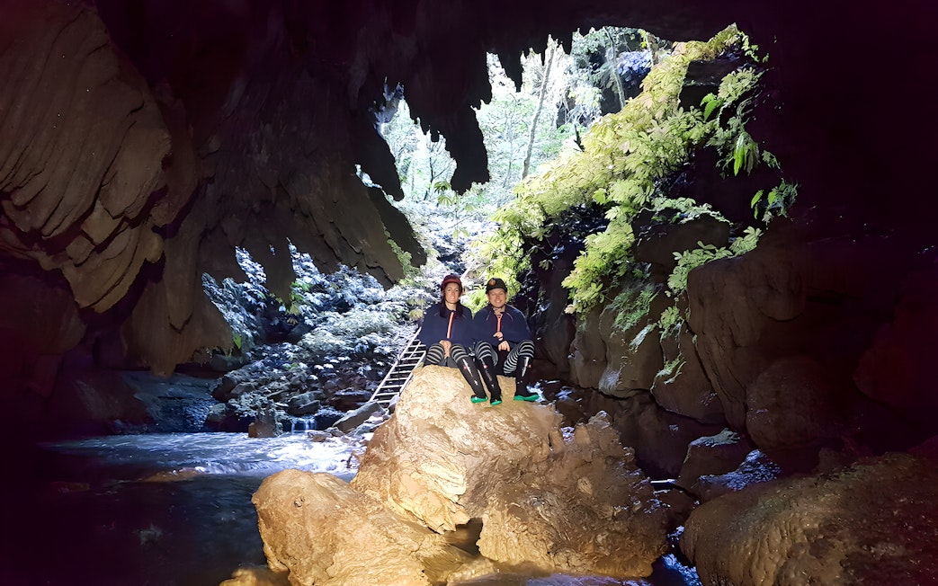 Visitors exploring Waitomo Glowworm Caves on a guided tour, New Zealand.