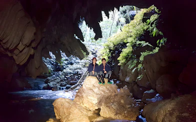 Visitors exploring Waitomo Glowworm Caves on a guided tour, New Zealand.