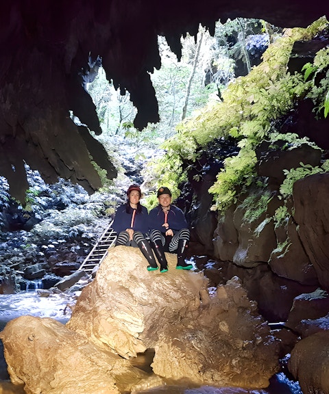 Visitors exploring Waitomo Glowworm Caves on a guided tour, New Zealand.