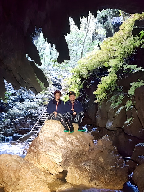 Visitors exploring Waitomo Glowworm Caves on a guided tour, New Zealand.