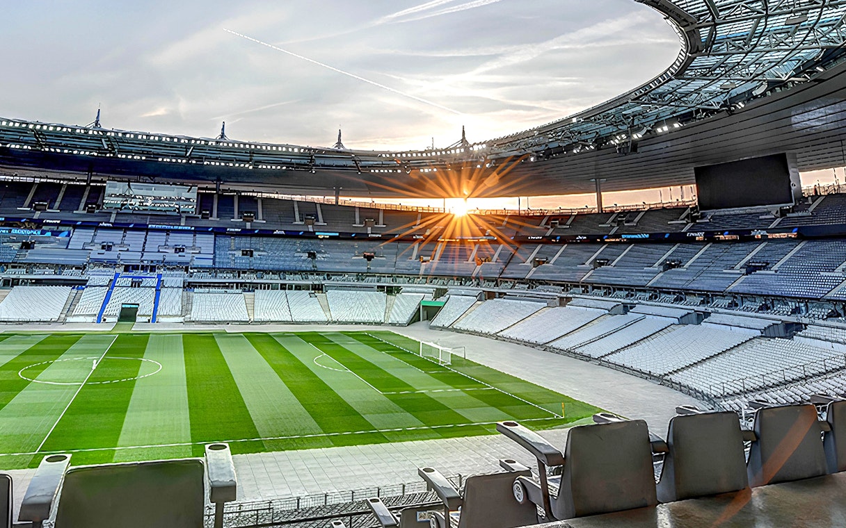 Stade de France interior with empty seats and field during guided tour.