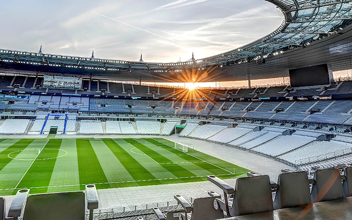 Stade de France interior with empty seats and field during guided tour.