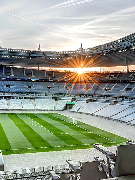 Stade de France interior with empty seats and field during guided tour.