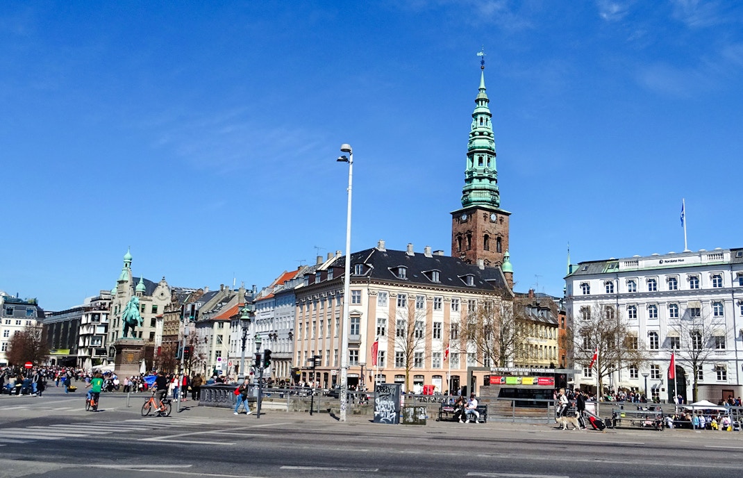 Nyhavn canal area with historic buildings and spire in København, Denmark.