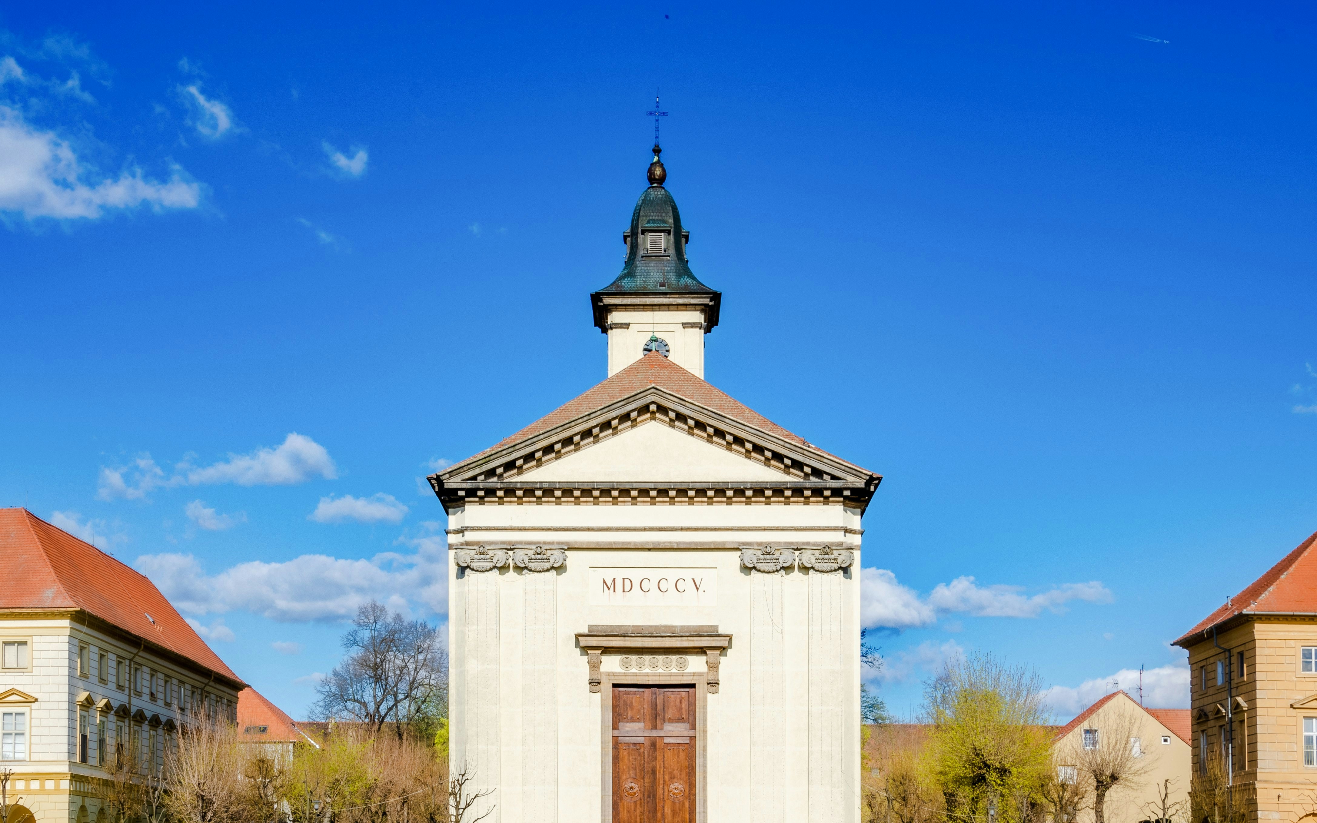 Church of the Resurrection of the Lord in Terezin with clear blue sky.