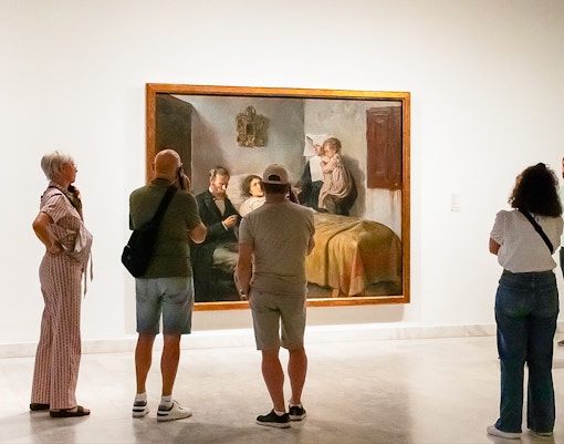 Visitors viewing a painting at the Picasso Museum during a skip-the-line guided tour.
