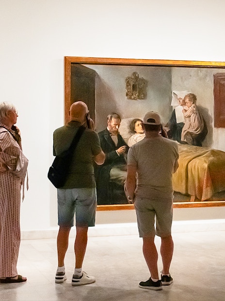 Visitors viewing a painting at the Picasso Museum during a skip-the-line guided tour.