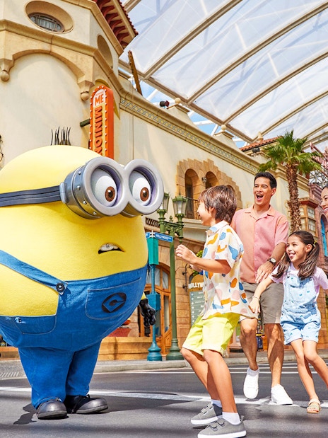 Family interacting with a Minion character at Universal Studios Singapore.