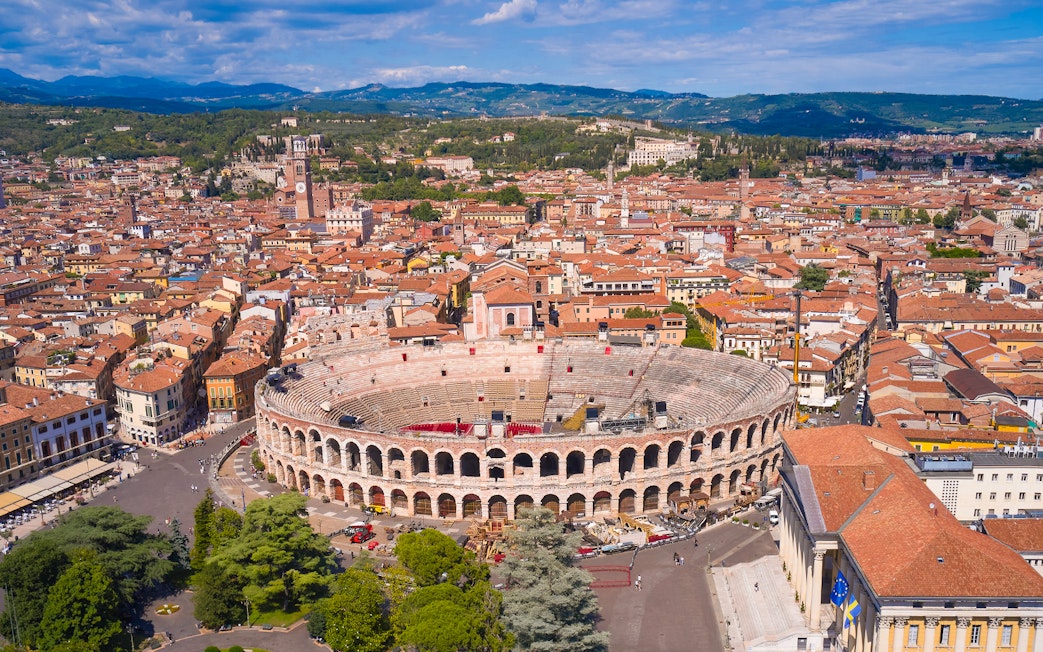 Aerial view of Verona Arena in Verona, Italy, surrounded by historic buildings.