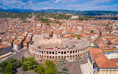 Aerial view of Verona Arena in Verona, Italy, surrounded by historic buildings.