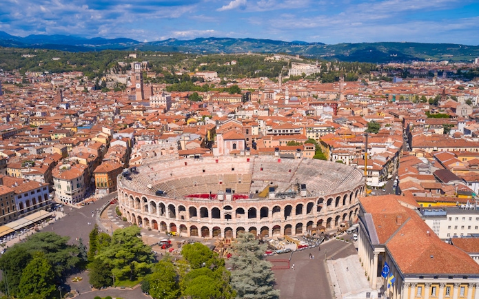Aerial view of Verona Arena in Verona, Italy, surrounded by historic buildings.