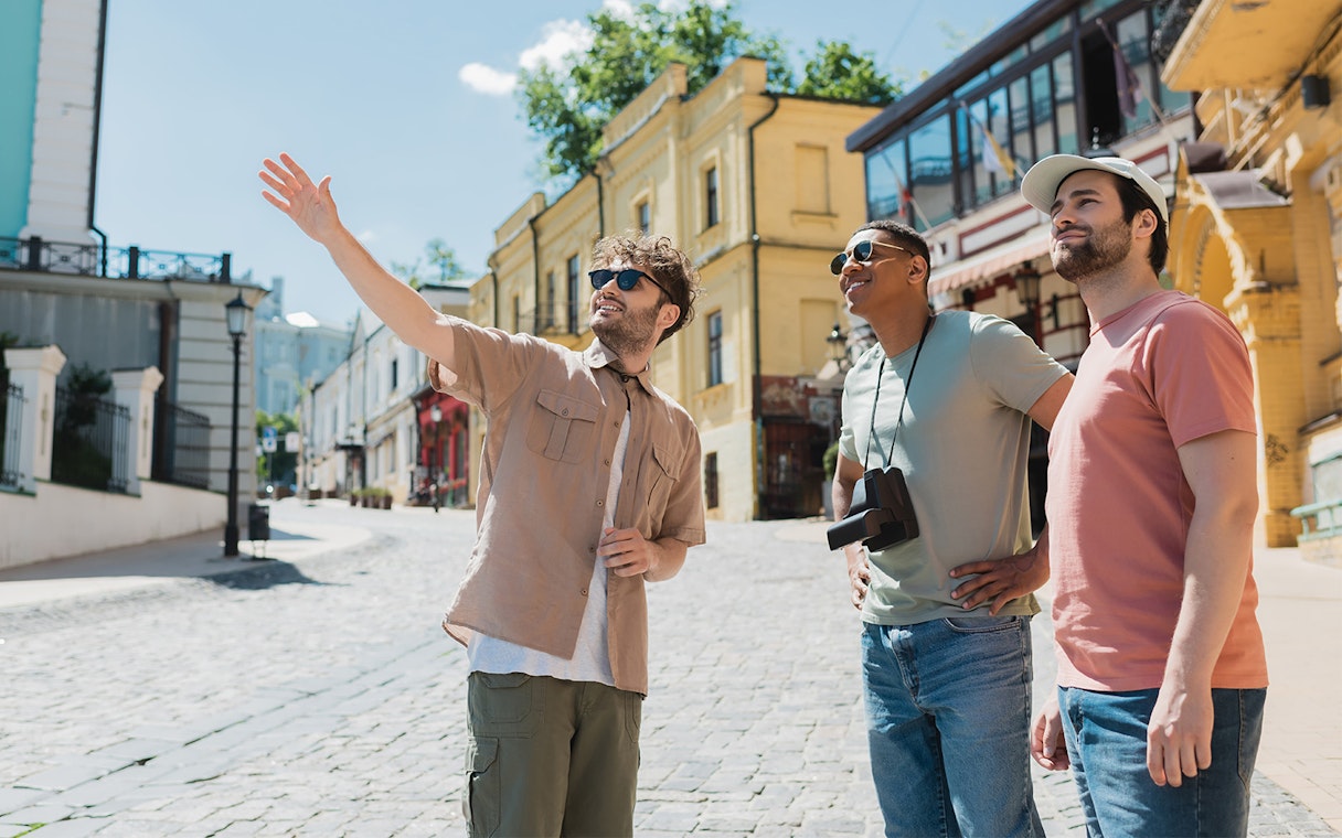 Tourists exploring a historic street with a guide pointing out landmarks.