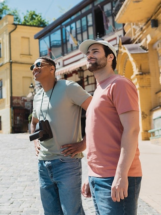 Tourists exploring a historic street with a guide pointing out landmarks.