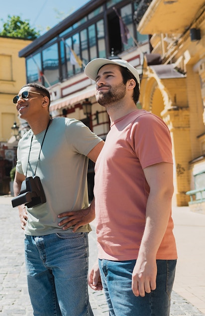 Tourists exploring a historic street with a guide pointing out landmarks.