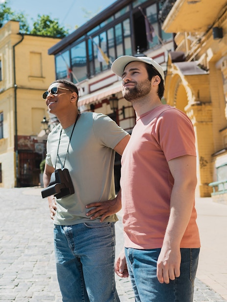 Tourists exploring a historic street with a guide pointing out landmarks.