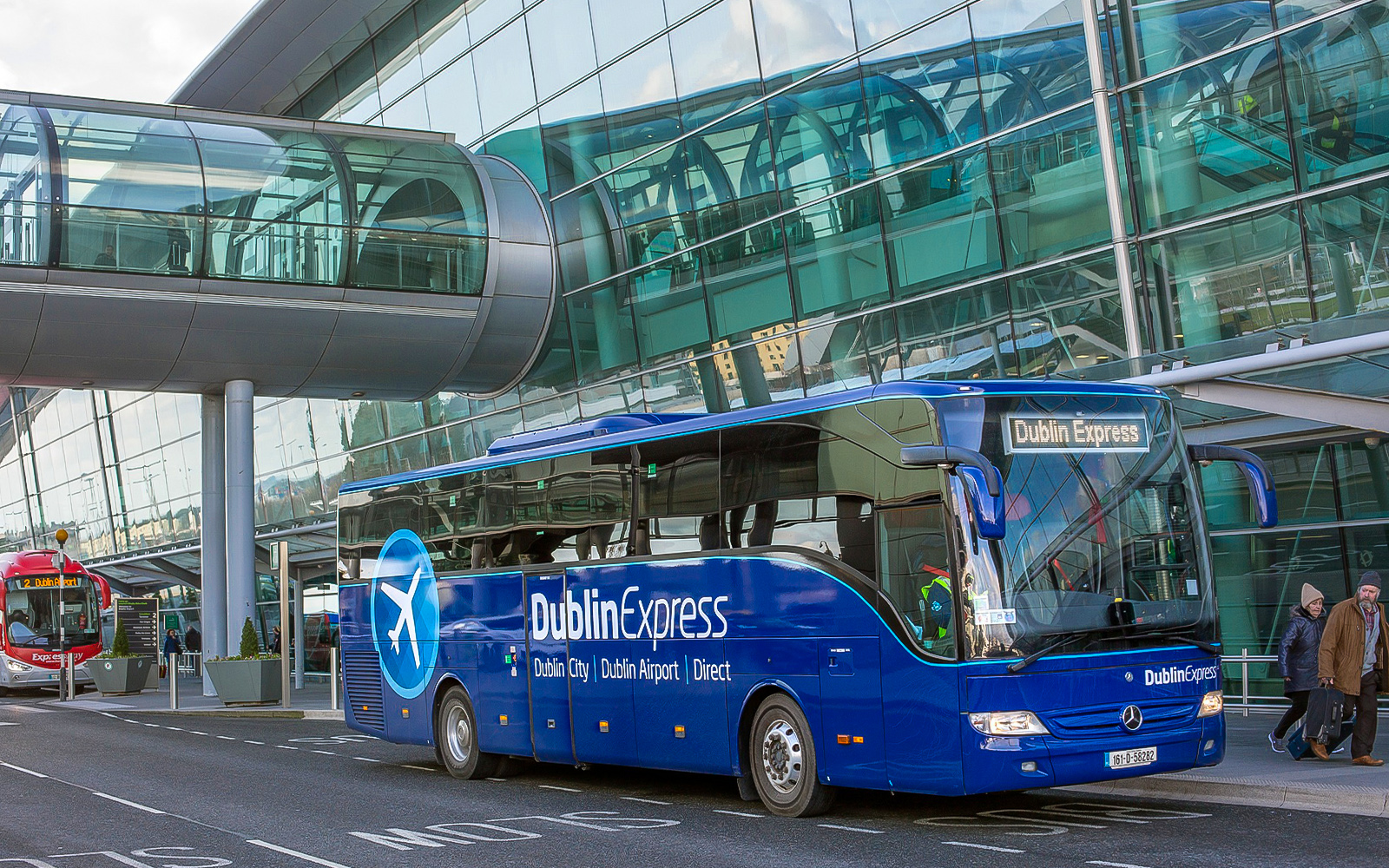Dublin Express bus at Dublin Airport terminal, offering round-trip service to Custom House Quay.