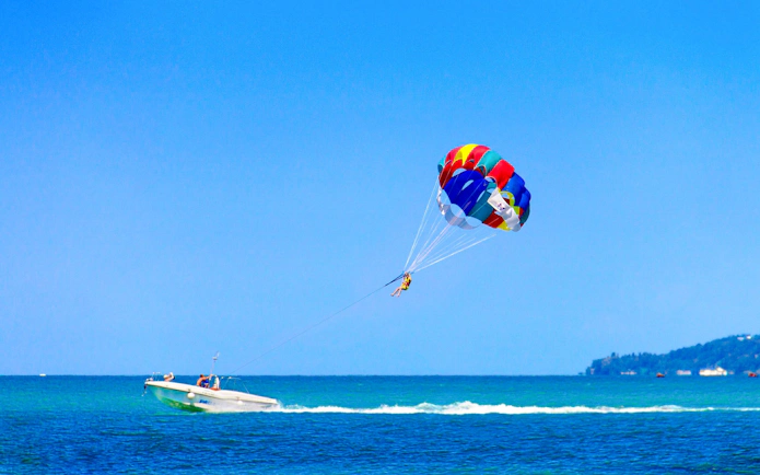 Parasailing over the ocean at Saona Island with a colorful parachute.