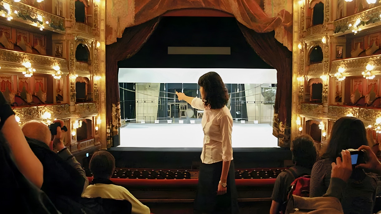 Tourist group with guide inside Teatro Colón, Buenos Aires, viewing stage.