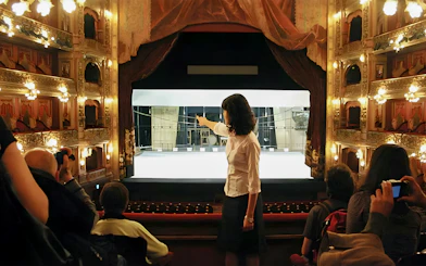 Tourist group with guide inside Teatro Colón, Buenos Aires, viewing stage.
