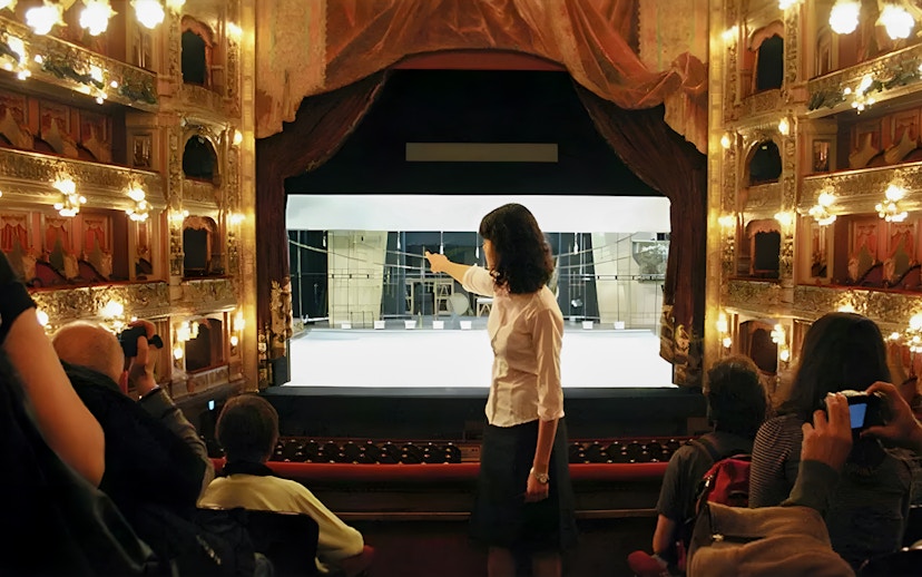 Tourist group with guide inside Teatro Colón, Buenos Aires, viewing stage.