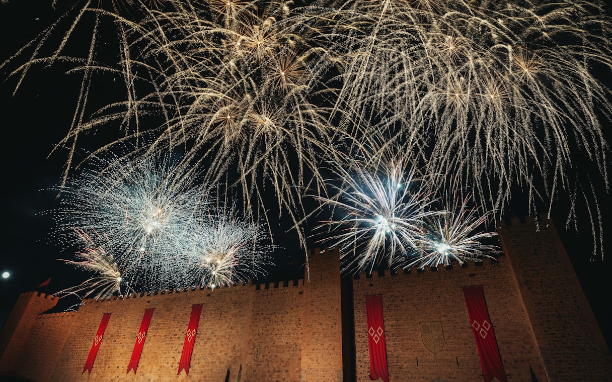 Fireworks display over castle walls during Christmas at Puy du Fou, España.