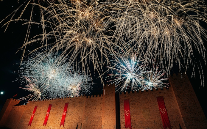 Fireworks display over castle walls during Christmas at Puy du Fou, España.