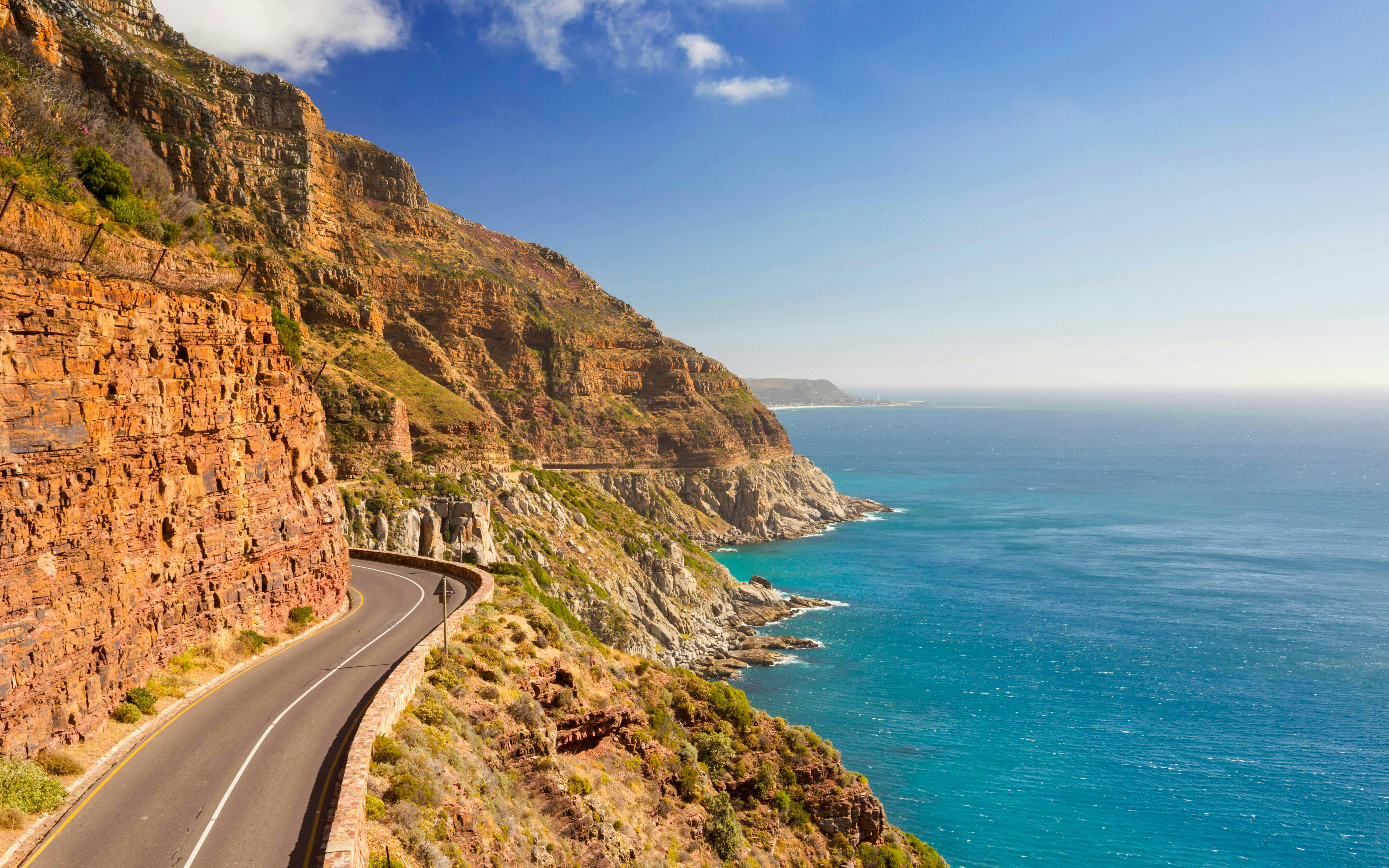 Chapman's Peak Drive winding along cliffs near Cape Town, South Africa, with ocean view.