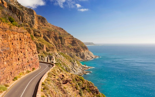 Chapman's Peak Drive winding along cliffs near Cape Town, South Africa, with ocean view.