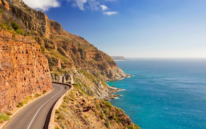 Chapman's Peak Drive winding along cliffs near Cape Town, South Africa, with ocean view.
