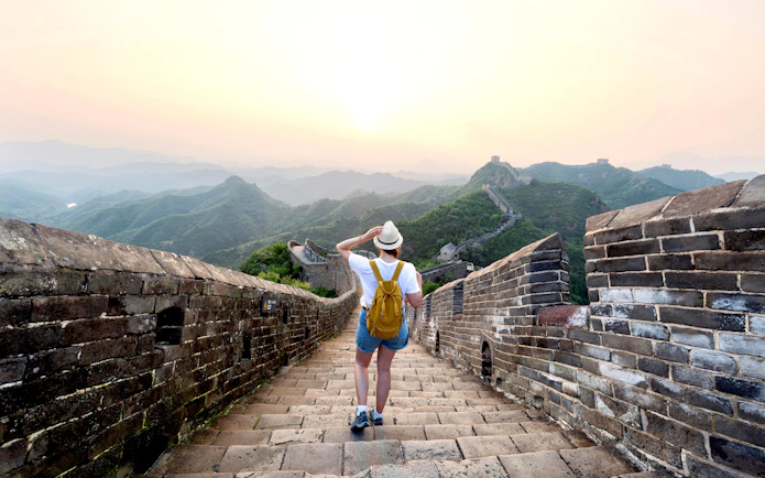 Traveler walking on the Great Wall of China at Badaling, Beijing, enjoying the view.