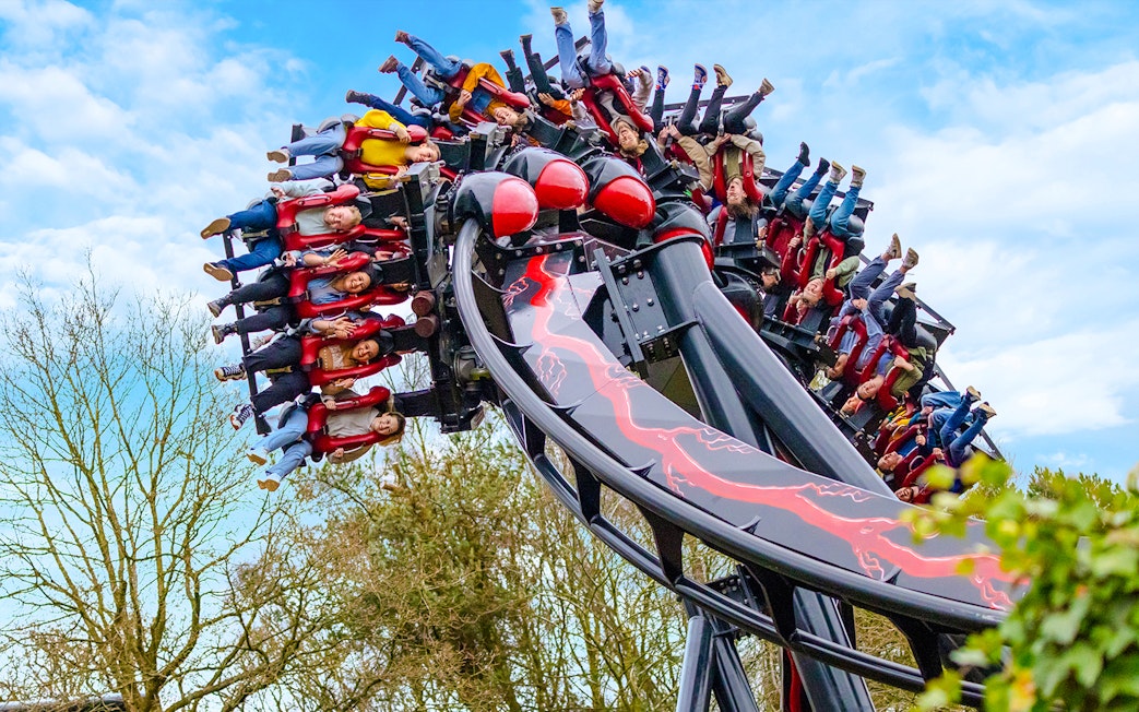 Riders upside down on Nemesis Reborn roller coaster at Alton Towers.
