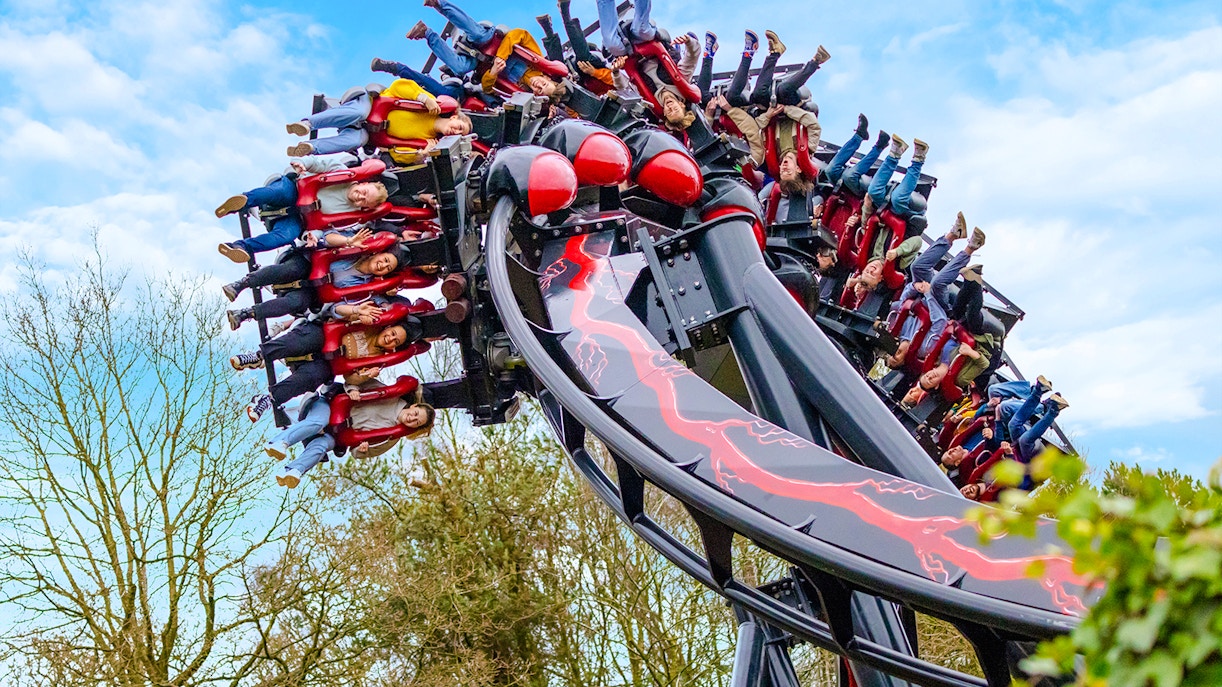 Riders upside down on Nemesis Reborn roller coaster at Alton Towers.