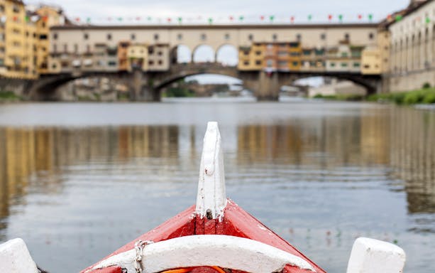 Gondola approaching Ponte Vecchio on a guided boat tour in Florence.