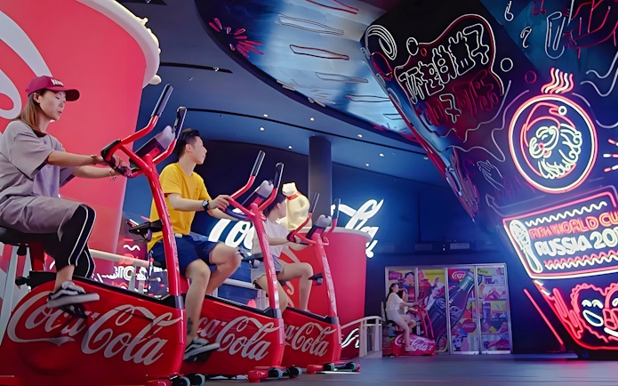 People biking at Coca-Cola mini park, Oriental Pearl Tower, Shanghai.