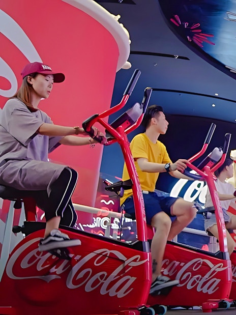 People biking at Coca-Cola mini park, Oriental Pearl Tower, Shanghai.