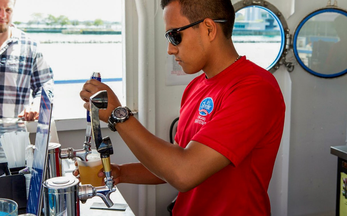 Bartender serving drinks on Lake Michigan Skyline Cruise.
