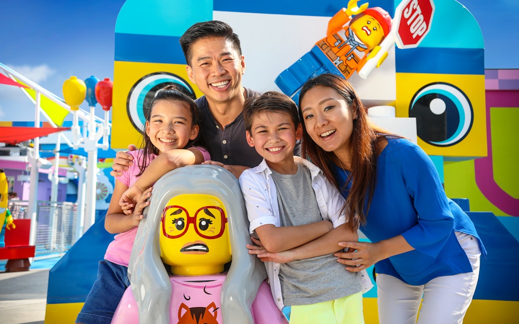 Family enjoying Legoland California with colorful Lego figures, included in San Diego All-Inclusive Pass.