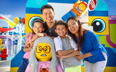 Family enjoying Legoland California with colorful Lego figures, included in San Diego All-Inclusive Pass.