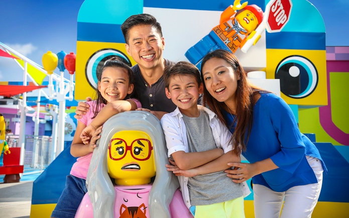 Family enjoying Legoland California with colorful Lego figures, included in San Diego All-Inclusive Pass.