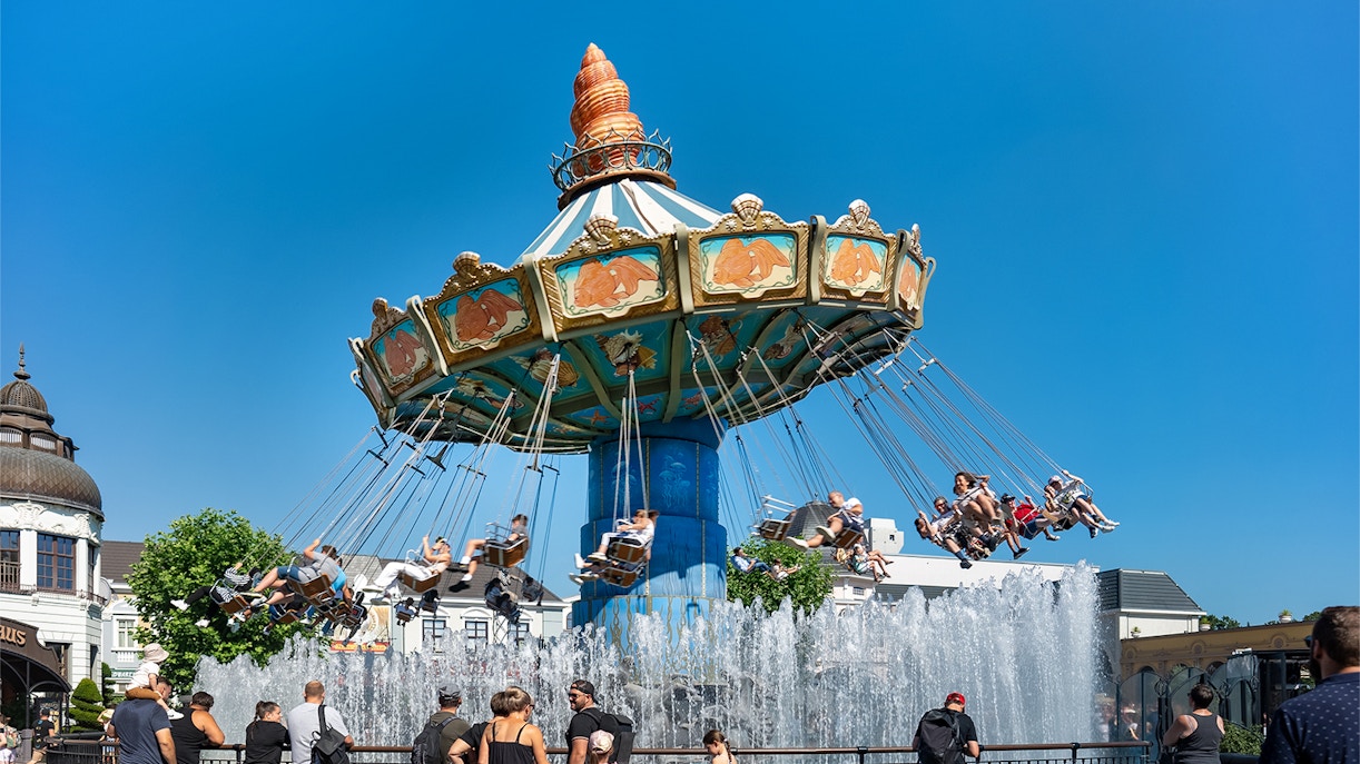 Wellenflug swing ride at Phantasialand theme park, Berlin, with colorful chairs in motion.