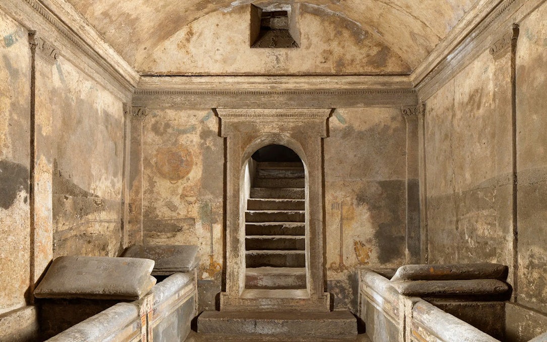 Ipogeo dei Cristallini ancient tomb with stone sarcophagi and arched entrance.