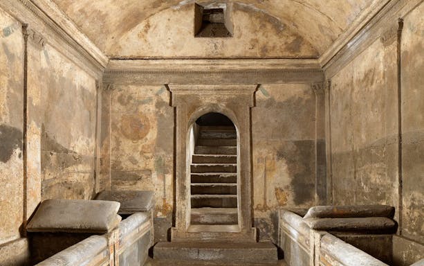 Ipogeo dei Cristallini ancient tomb with stone sarcophagi and arched entrance.