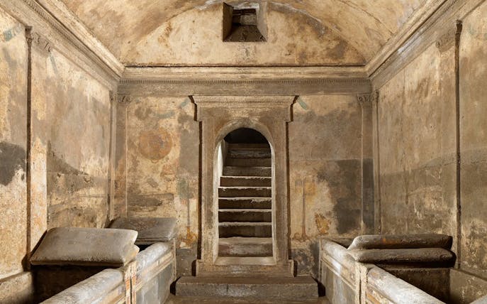 Ipogeo dei Cristallini ancient tomb with stone sarcophagi and arched entrance.