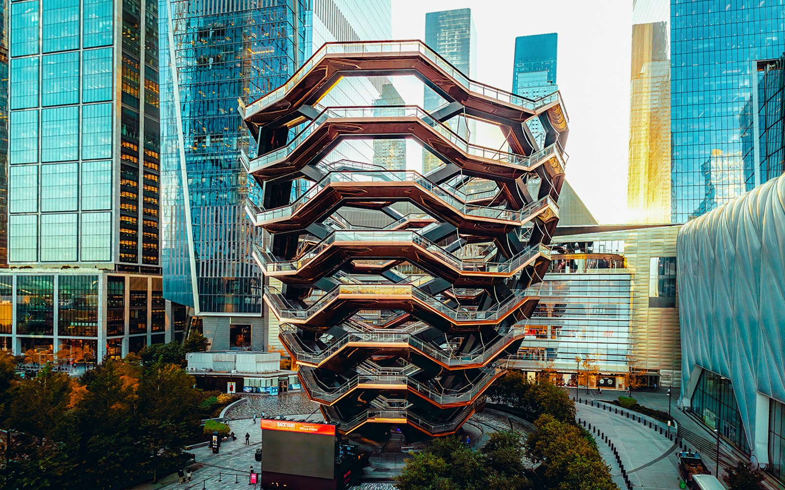 Vessel structure in New York's Hudson Yards with visitors on interconnected staircases.