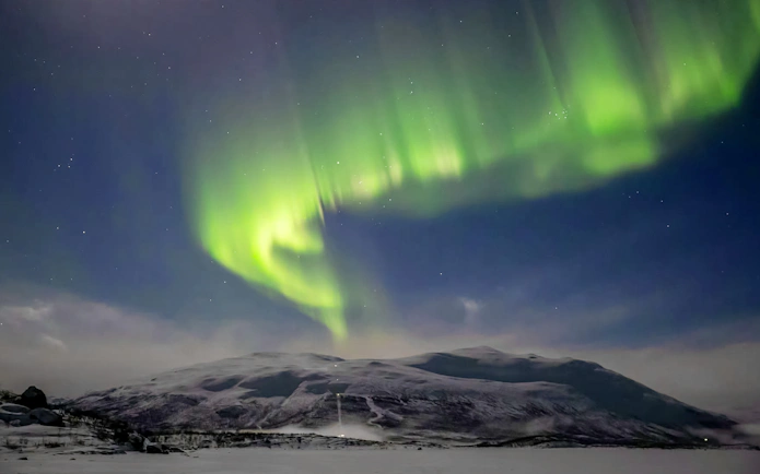 Northern lights over Mount Nuolja in Abisko National Park, Sweden.