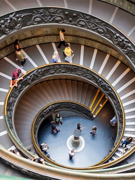 Vatican Museum spiral staircase with visitors, part of Combo: Vatican Museum + 48-Hr Rome Pass.