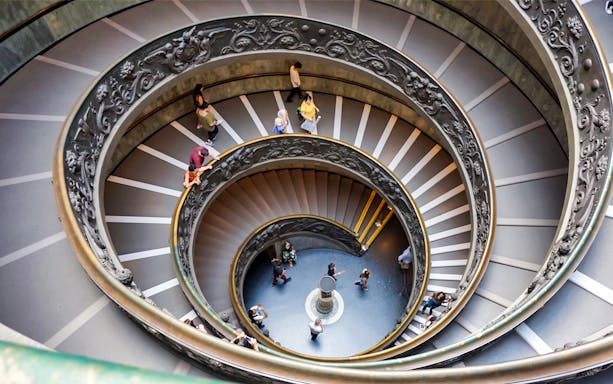 Vatican Museum spiral staircase with visitors, part of Combo: Vatican Museum + 48-Hr Rome Pass.